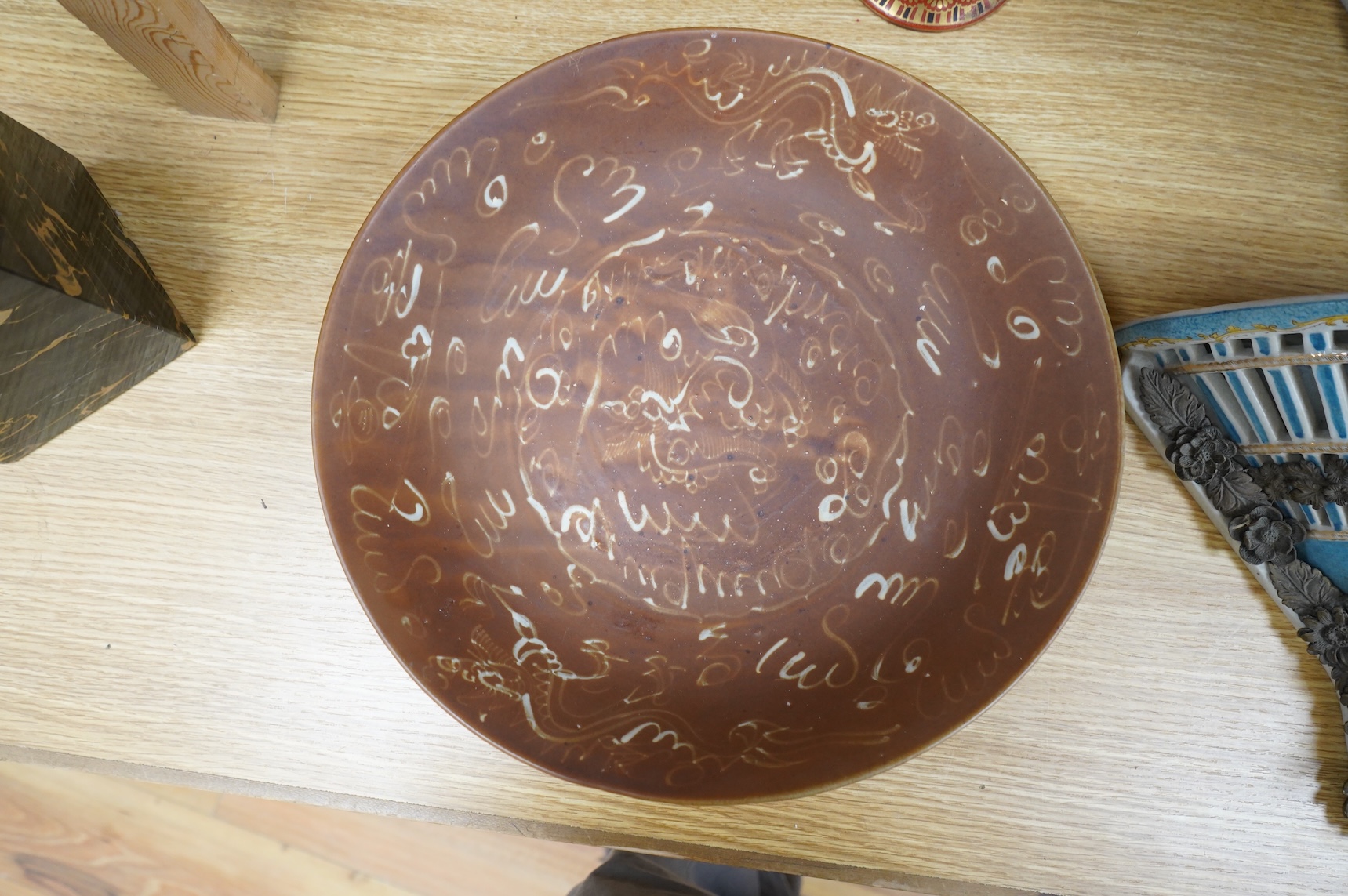 A Chinese late Ming iron brown glazed 'dragon & lion' dish, from a shipwreck, 35cm